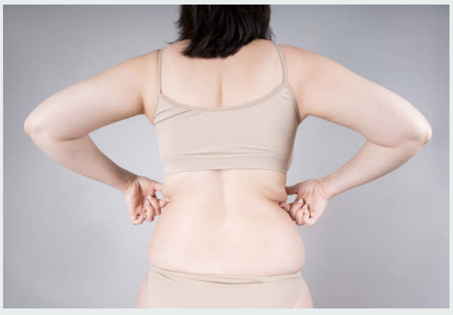 Person exercising with focus, symbolizing determination in targeting stubborn fat for improved fitness and health